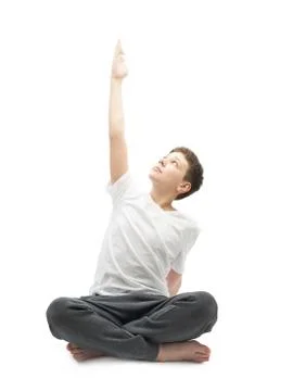 Young boy stretching or doing yoga Stock Photos