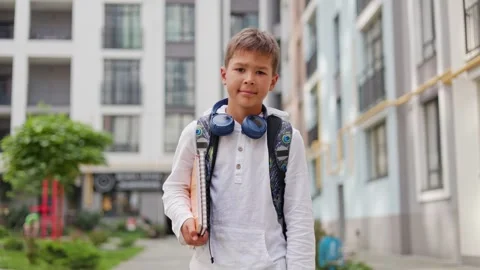 Young Boy Student Going to School Wearing Backpack and Holding Notebook. Stock Footage 249208298