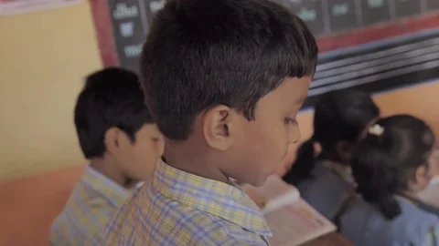 A young boy student reading a lesson in the class. Video stock 104988481