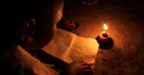 A young boy studying for his homework at nigh with a Kerosene Oil Lamps 스톡 동영상 109139307