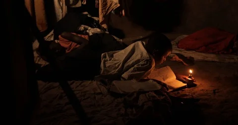 A young boy studying for his homework at nigh with a Kerosene Oil Lamps Stock Footage 109139320