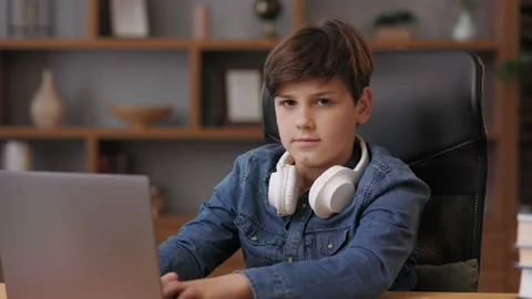 Young boy studying remotely at home using laptop. Cute schoolboy doing homework 스톡 동영상 203796458