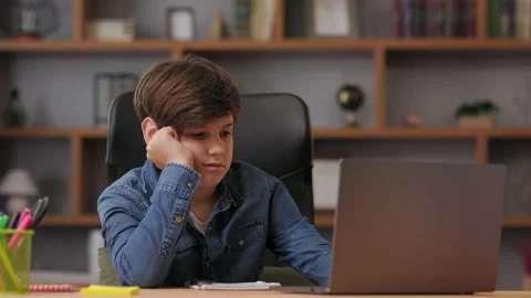 Young boy studying remotely at home using laptop. Sad schoolboy feeling bored Stock-Footage 213282948