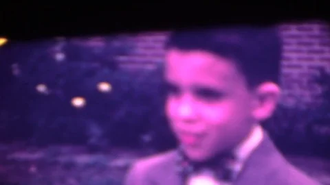 Young boy in suit has moment of discovery, 8mm home movie Stock Footage