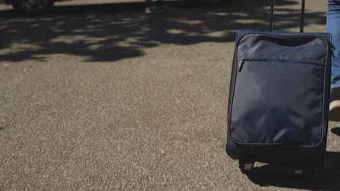 A young boy with a summer hat and suitcase meets and greets his friend, Covid Stock Footage 155248987