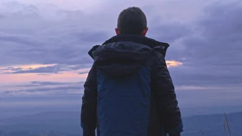 Young Boy at Sunset on Mountain with Forest, trees and valley below Stock Footage 144207309