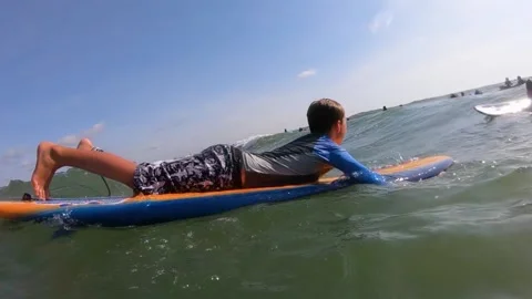 Young boy surfing Stock Footage 135664077