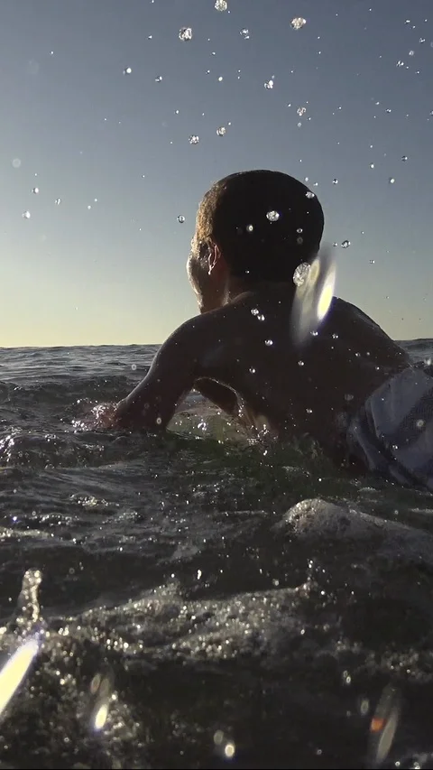 Young Boy surfing jumping waves Body Board at the beach. Vertical, Social Media Stock Footage 121620139