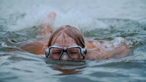 Young Boy Swimming Toward Camera in River During Summer Stock Footage 344680561
