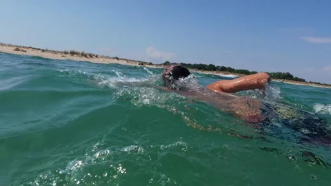Young Boy Swimming Towards Sandy Shore in Clear Sea Water on Summer Day Stock Footage 344549575