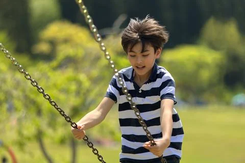 A young boy on a swing Stock Photos