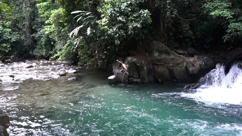 Young Boy Swinging With Rope Into River With Waterfall 2 [Slow Motion] Stock Footage 88899295