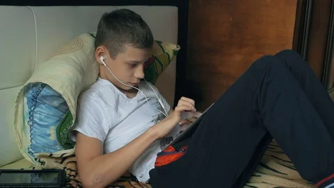 Young boy with tablet computer in home Stock Footage 69865423