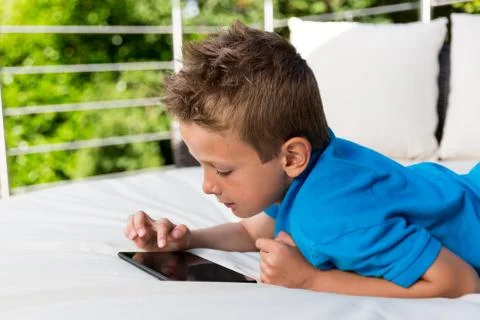 Young boy with a tablet Stock Photos