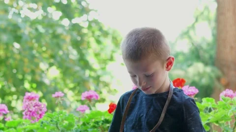 Young boy is taking a picture with an old camera 動画素材 135381106