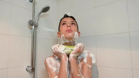 Young Boy Taking a Shower with a Handheld Shower Head Stock Footage 340500074