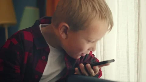 Young boy talking on the phone Stock Footage 165340807