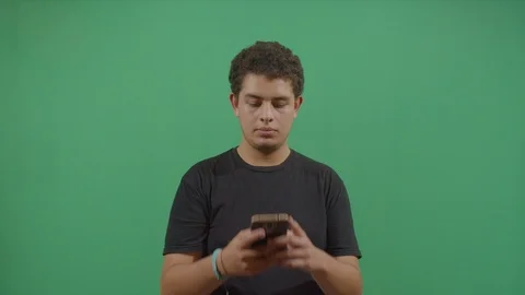 Young boy texting on a mobile phone with great hate in ecuador Stock Footage 115339510