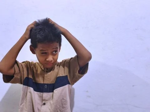 Young boy with a thoughtful expression Stock Photos