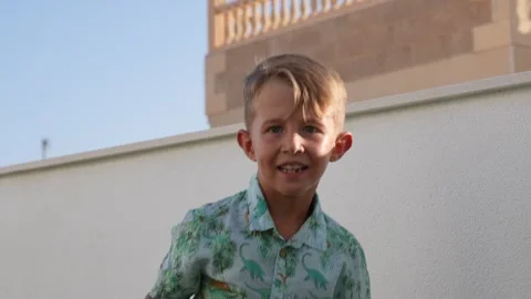 Young Boy Throwing a Ball Outdoors on a Sunny Day Vidéo 342621304