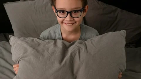 Young boy throwing a pillow. Concept of fun and joy at home. Stock Footage 165102142