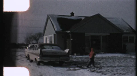 Young boy throwing snowballs with sled winter 1950s - hd 8mm film Video stock 38107228