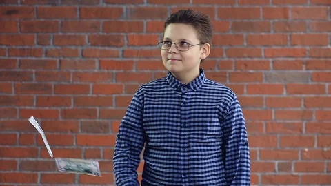 A young boy throws money with his hands Stock Footage 108835510