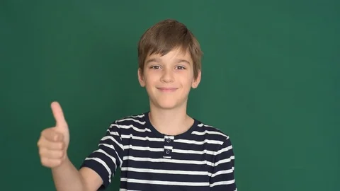 Young boy with thumb up on the green screen Video stock 118378339