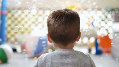 Young boy toddler watching bubbles 120fps Stock Footage 128601627