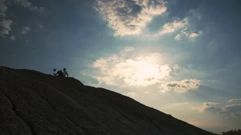 A young boy on top of a mountain performs tricks with a soccer ball Видео 133509738
