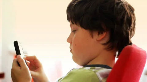 Young boy with touchscreen phone Stock Footage 844224