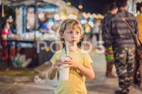 Young boy tourist on Walking street Asian food market Stock Photos