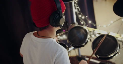 Young boy traning play electronic instrument musical drums at living room. Self 스톡 동영상 132107380