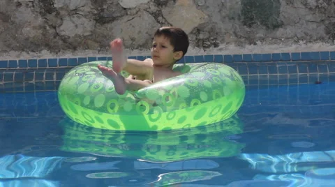 A young boy on a tube in the pool Stock Footage 1067576