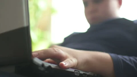 Young boy typing on laptop Stock Footage 152956693
