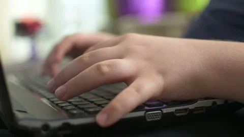 Young boy typing on laptop Stock Footage 152956926