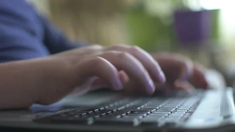 Young boy typing on laptop Stock Footage 152957903