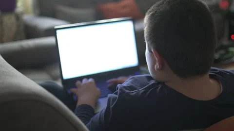 Young boy typing on laptop Stock Footage 152958108