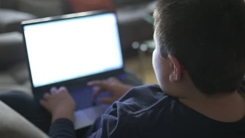 Young boy typing on laptop Stock Footage 152958364