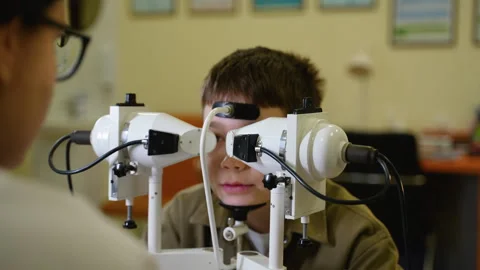Young boy undergoing comprehensive eye examination with optometrist Video stock 310806725