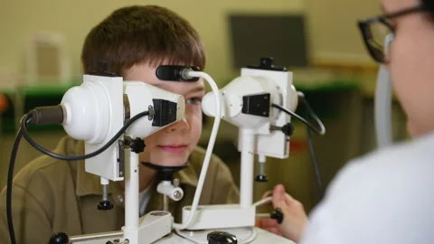 Young boy undergoing comprehensive eye examination with modern equipment Stock Footage 310806867