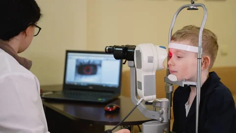 Young boy undergoing comprehensive eye examination by optometrist Video stock 310809986
