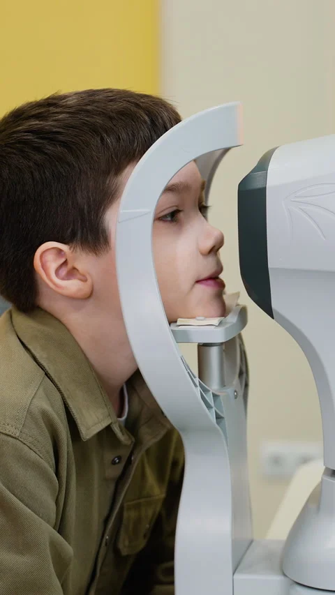 Young boy undergoing comprehensive eye examination at modern clinic Stock Footage 310811947