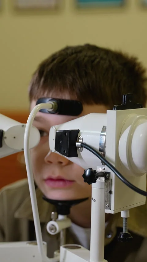 Young boy undergoing comprehensive eye examination with medical equipment Stock Footage 310812002
