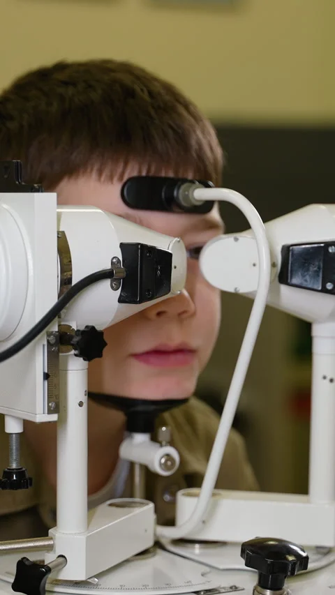 Young boy undergoing comprehensive eye examination at ophthalmology clinic Stock Footage 310812009