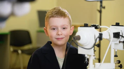 Young boy undergoing eye exam with modern equipment Stock Footage 310807593