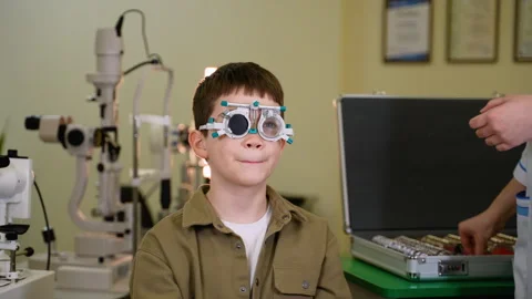 Young boy undergoing eye examination with trial frame Stock Footage 310810627