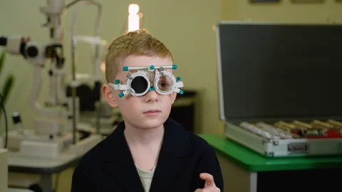 Young boy undergoing eye examination with trial frame Stock Footage 310811135