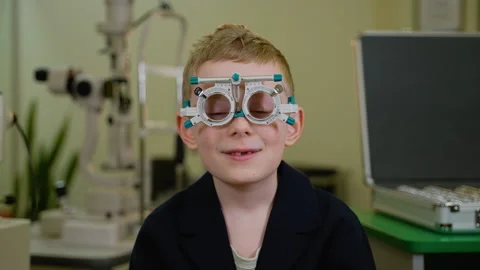 Young boy undergoing eye examination with trial frame Stock Footage 310811184