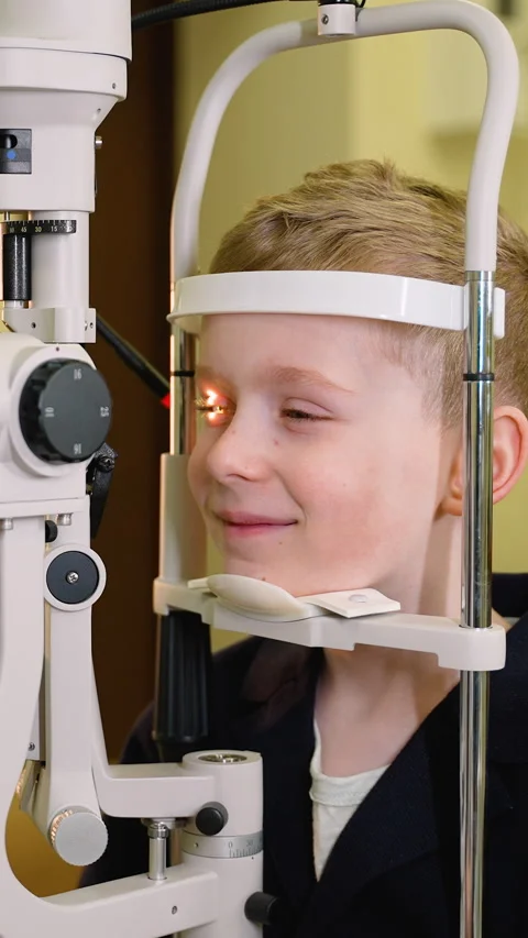 Young boy undergoing eye examination with modern medical equipment Stock Footage 310812061